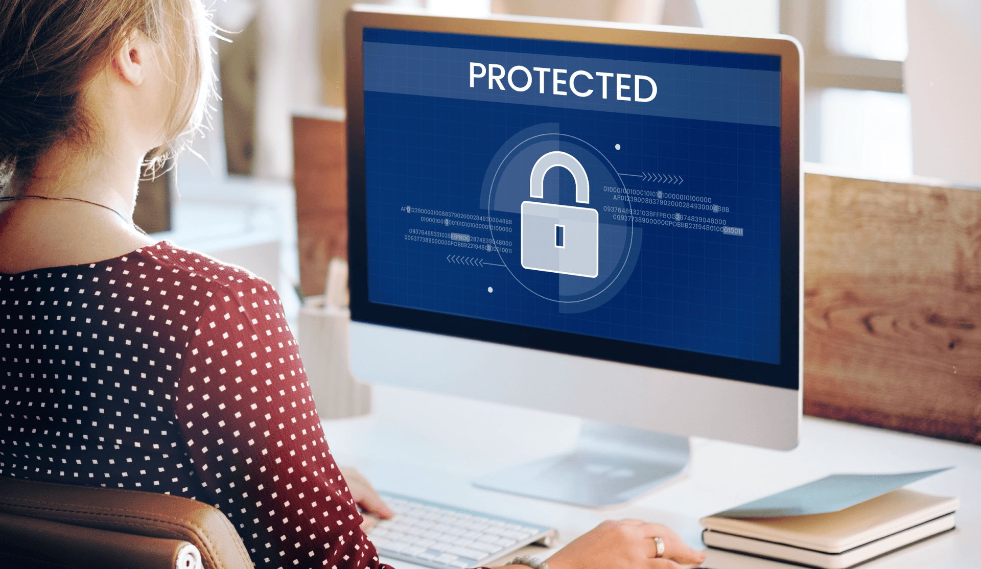woman using computer with a protected graphic on the screen